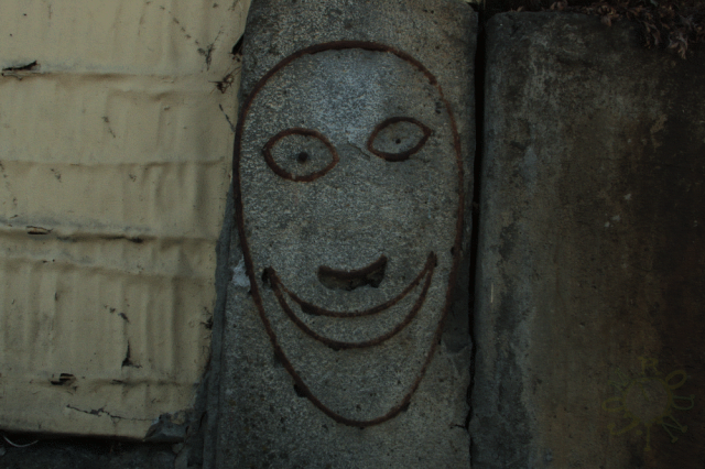 Happy metal concrete face ; sunny spring day